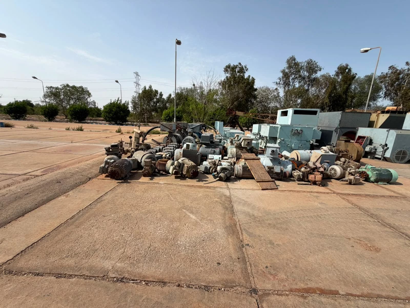 Used industrial electric motors grouped in an outdoor Pakistani yard