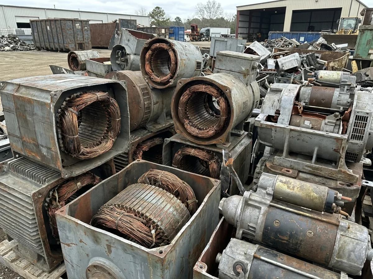 Mixed industrial electrical equipment including transformers, alternators, and generator units staged for container export